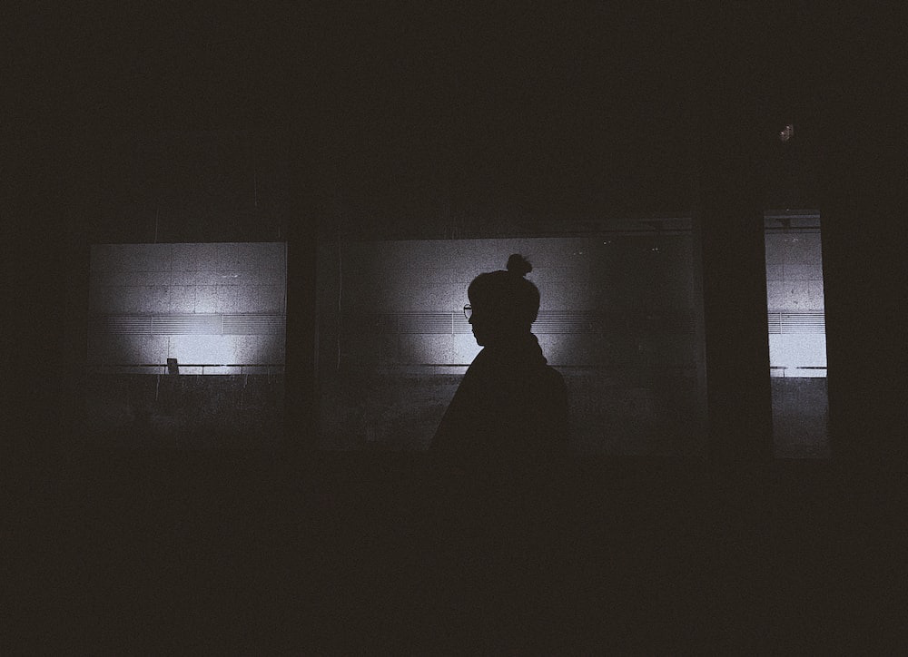 A silhouette in a dark room